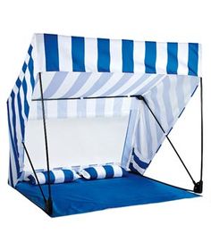 a blue and white striped tent with the door open