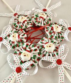 some white and red christmas decorations with bows around them on a table next to toothbrushes