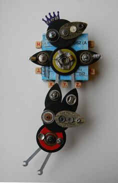 a clock made out of different types of buttons and screws on a white surface