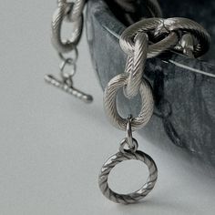 Our exclusive and bestseller, a chunky and iconic statement piece. Our Aura Large Link Chain Necklace is comprised of 3mm thick links, masterfully textured with lines, each measuring 11mm x 13mm, with a toggle clasp closure. This beauty can be worn alone, with the toggle clasp toward the front, side or back (so many options!). If you're feeling intrepid, you can also rock this necklace with other statement pieces. Details Waterproof & Sweat Resistant Material: Stainless Steel Closure: Toggle Len Chain Bracelet Silver, Chain Necklace Silver, Link Chain Bracelet, Link Chain Necklace, Silver Chain Bracelet, Silver Chain Necklace, Toggle Clasp, Chain Link Necklace, Link Chain