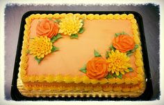 a cake decorated with flowers on top of a table