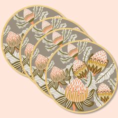 three plates with designs on them sitting next to each other in front of a pink background