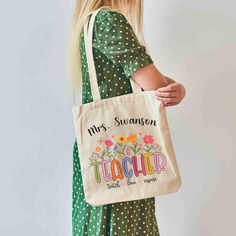 Adorable, personalized teacher tote bag!  This 100% cotton bag measures 15" x 16" with 20" handles (made from the same canvas), making it easy to carry all those teacher supplies! * 100% cotton canvas * Heavy fabric (12 oz/yd² (406.9 g/m * Sewn-in label * Natural color SHIPPING: All items are made to order via a print partner before shipping USPS from their location. RETURNS: I offer a 30-day exchange or refund policy on all non-custom items. If you are not happy with your purchase, just let me Custom Teacher Gifts, Painted Tote, Teacher Tote, Teacher Supplies, Teacher Name, Cotton Bag, Canvas Bag, Sew-in Labels, Custom Items