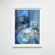 a painting is hanging on the wall next to a vase with flowers and plates in it