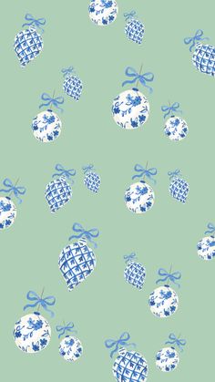 blue and white baubles with bows on a light green background seamless wallpaper