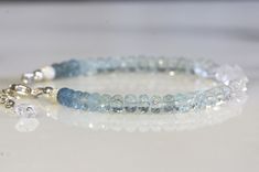 Aquamarine, Herkimer diamond, gold filled/ sterling silver. Length: 6.5 inches, and 2 inches chain extender. Bead diameter: about 4.5-5 mm. Beautiful ombre aquamarine and Herkimer diamond bracelet.  Made with facet aquamarine rondelle beads, natural Herkimer diamond beads, gold-filled findings, and Softflex strong beading wire. The bead's color changes gradually from blue aquamarine of different shades to very clear Herkimer diamond. The facet cut has added sparkle to the bracelet under sunshine Sterling Silver Rondelle Jewelry As A Gift, Stackable Rondelle Jewelry For Gift, Sterling Silver Faceted Rondelle Jewelry, Sterling Silver Rondelle Faceted Jewelry, Dainty Blue Rondelle Jewelry, Everyday Blue Topaz Jewelry, Minimalist Everyday Blue Topaz Jewelry, Adjustable Birthstone Jewelry With Blue Topaz, Adjustable Blue Topaz Birthstone Jewelry