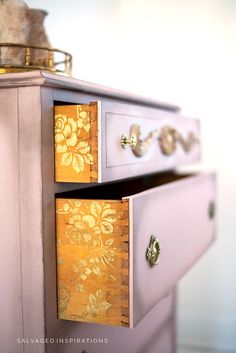 the drawers are painted pink and gold with floral designs on them, as well as a teddy bear