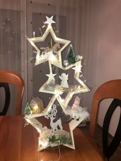 a christmas tree made out of wooden stars with lights on the top and around it