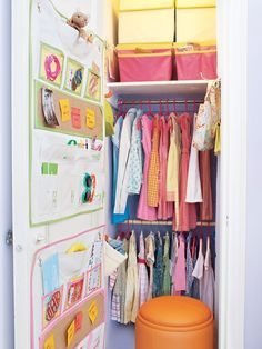 the closet is filled with colorful clothes and storage bins for children's clothing