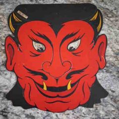 an image of a red demon mask on the ground