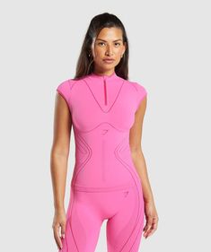 a woman in a pink body suit