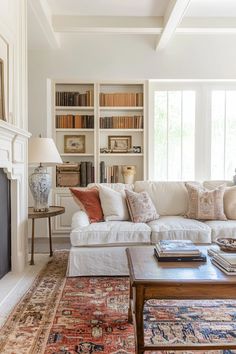 a living room filled with furniture and bookshelves next to a fire place in front of a fireplace