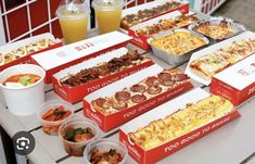 many different types of pizzas and drinks on a table