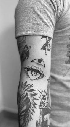 a man's arm with tattoos on it, including an eye and other things