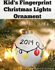 a christmas ornament hanging from a tree with text overlay that reads, how to make your own kid's fingerprint christmas lights ornament