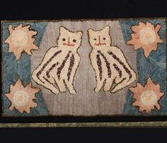 two cats sitting on top of a rug in the shape of sunbursts