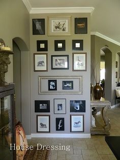 a living room filled with lots of pictures on the wall