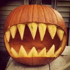 a carved pumpkin with sharp teeth on the outside