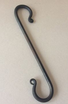 an old metal hook on a white surface