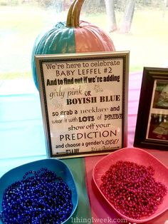 two bowls filled with beads next to a sign