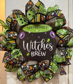 a wreath that says witches brew on it