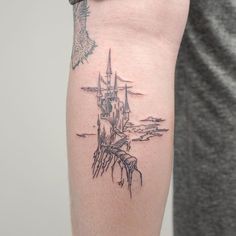 a man with a tattoo on his arm has a castle in the middle of it