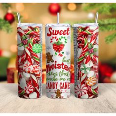 two christmas candles with candy canes and candies on them, sitting next to each other