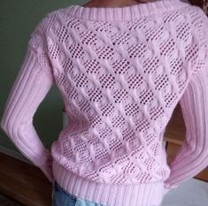 the back of a woman's sweater that is made from pink knitted material