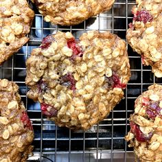 several cookies with cranberries and nuts are cooling on a rack in the oven