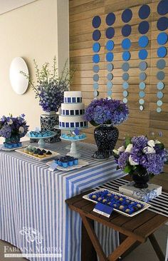 a table topped with blue and white desserts