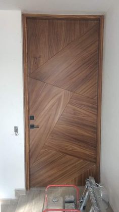 a wooden door with some tools on the floor