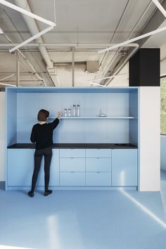 a man standing in front of a blue counter