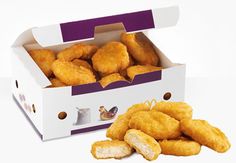 chicken nuggets in a white box on a white surface with purple trim around the edges