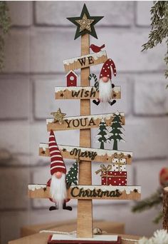 a wooden christmas tree with gnomes on it