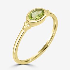 Designed with genuine peridot, this gold over sterling silver ring offers a pop of color to any outfit.  Includes a black gift pouch. Gold Oval Peridot Birthstone Ring, Country Rings, Midi Ring, Information Design, Peridot Gemstone, Midi Rings, Green Peridot, Gift Pouch, Black Gift