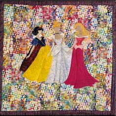 three women in dresses are standing together on a patchwork quilted wallhanging