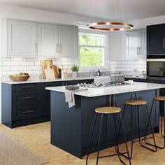 a modern kitchen with blue cabinets and white counter tops