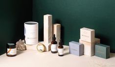 several different types of skin care products sitting on a white table next to each other