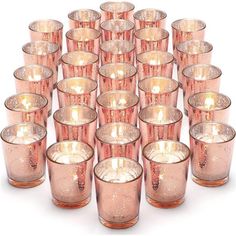 a large group of pink glass candles sitting next to each other