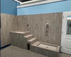 a bathroom with tiled walls and steps leading up to the door