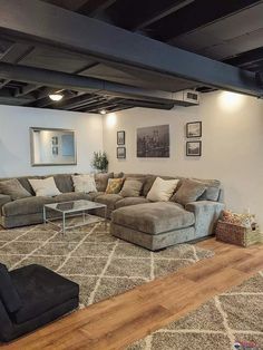 a living room filled with lots of furniture and decor on top of a hard wood floor