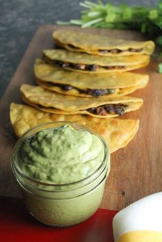 some tortilla chips and guacamole on a cutting board