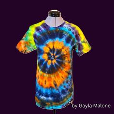 Twisted & Tied is proud to offer a custom dyed "Spiral" tie dyed shirt by shop artist: Gayla Malone! 🌈 Tie-Dyed 100% Cotton T-Shirt - Boho Hippie Vibe 🌈 Step into the vibrant world of bohemian fashion with our colorful, hand-dyed tie-dye T-shirt! Crafted from 100% premium cotton, this unisex t-shirt offers unbeatable comfort and style. Pre-shrunk and colorfast, it maintains its vivid hues and perfect fit wash after wash. Ideal for summer or year-round wear, this piece brings a carefree hippie vibe to any wardrobe. Embrace the unique charm and individuality of this boho essential! SIZE:  Small (adult) Shipping is FREE! (within the US - shipping and handling added for international packages) Hand Dyed Acid Wash T-shirt For Festivals, Festival Cotton Bleached T-shirt, Festival Bleached Cotton T-shirt, Bleached Cotton T-shirt For Festivals, Hippie Hand Dyed Tie Dye T-shirt, Hippie Tie Dye T-shirt For Festivals, Hippie Hand Dyed Festival T-shirt, Hand Dyed Hippie Short Sleeve T-shirt, Hippie Hand-dyed Festival T-shirt