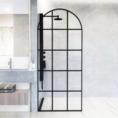 an open shower door in a white bathroom