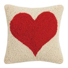 a red heart on a white pillow