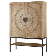 a wooden cabinet with metal legs and a circular design on the front, against a white background