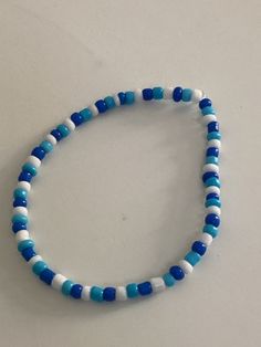 a blue and white beaded bracelet on a table