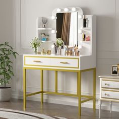 a white and yellow vanity with lights on it next to a potted green plant