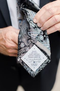 a close up of a person wearing a suit and tie with a label on it