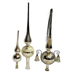 three silver vases and two bells on a white background, one has a long tail